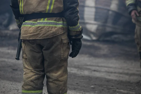 Firefighter rescue working from burning building  in fire and smoke  incident.