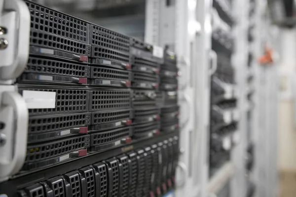 Computer Server mount on rack in data center room with red lighting alarm.