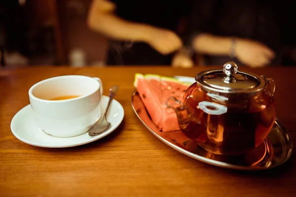 Process brewing tea,tea ceremony,Cup of freshly brewed black tea,warm soft light, darker background.