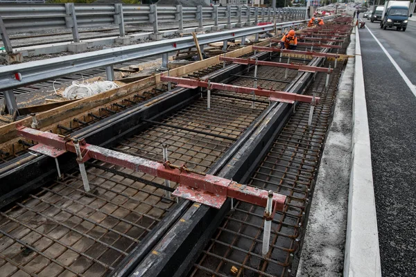 Repair of the railway tram line. Installation of new modern silent railway rails for trams. Laying of stone paving, road paving slabs on street. Repair of reconstruction of city roads with a tram line