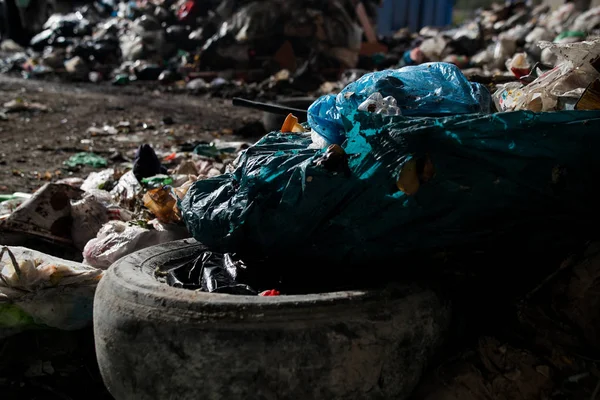 Garbage pile in trash dump or landfill, Waste from household in waste landfill, waste disposal in dumping site, excavator machine is working on a mountain garbage.