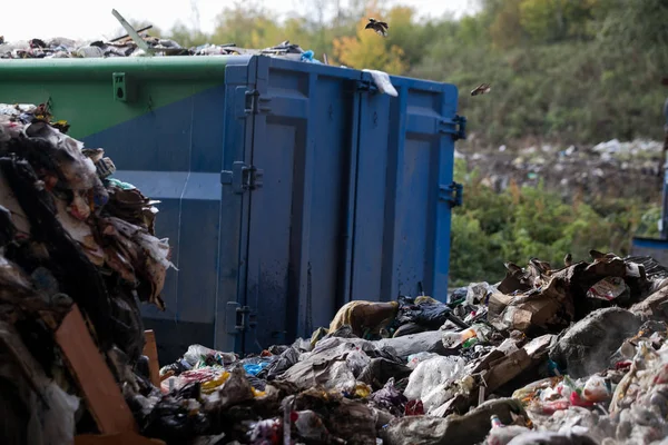 Garbage pile in trash dump or landfill, Waste from household in waste landfill, waste disposal in dumping site, excavator machine is working on a mountain garbage.