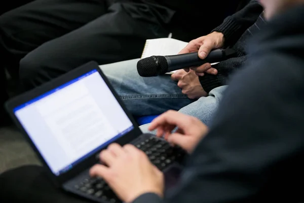 Press officer of a company giving interview to journalist with a microphone