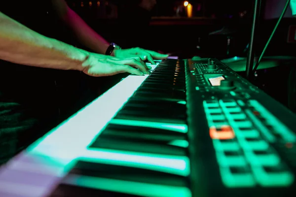 playing the synthesizer concert, hands on the keys