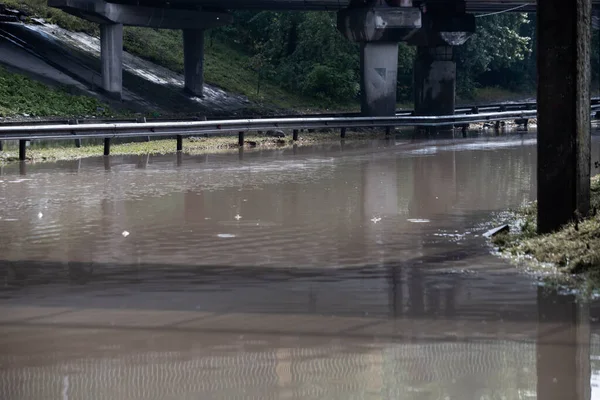 Heavy rain and puddles on the road slowing the traffic down