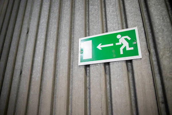 Emergency exit sign, escape sign on the wall. Safety sign in office company for exit building.