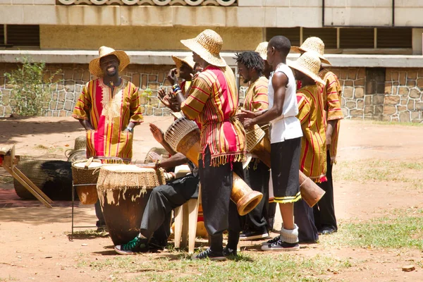 Smiling drummer performs traditional music with hand drum group — ストック写真