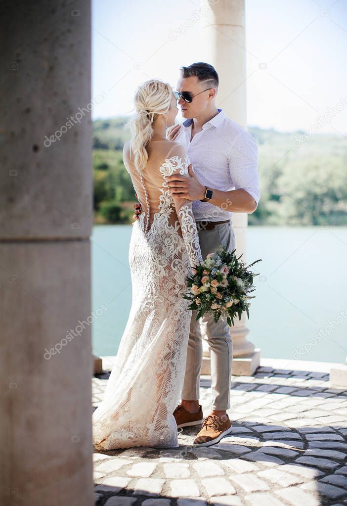 young beautiful couple posing on wedding photo session 