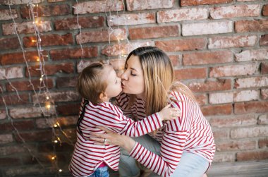 Anne ve kızı yeni yıl fotoğraf oturumunda poz 