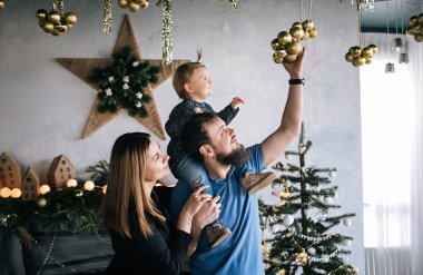 Genç mutlu aile anne, baba ve kız Noel fotoğraf oturum poz 
