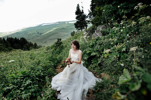 Beautiful young bride posing outdoors