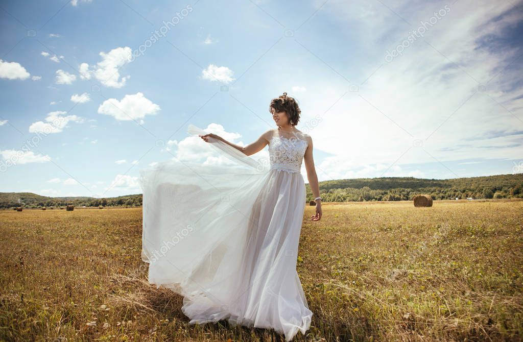 beautiful young bride posing outdoors 