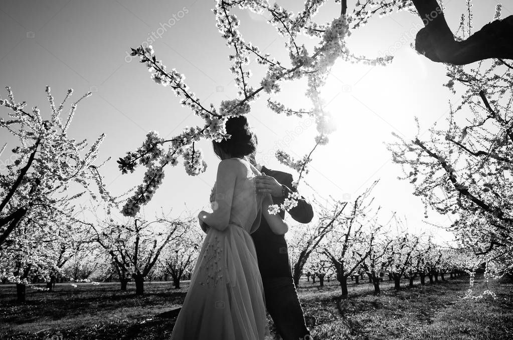 black and white photo outdoors of newlyweds