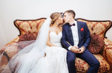 Gelin ve damat güzel elbise beyaz vintage iskemlede ve sarılma - düğün fotoğraf stüdyosu 