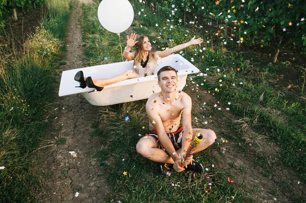 Man Woman Sitting Bath Rose Petals Middle Vineyards Blowing Popper — Stock Photo, Image