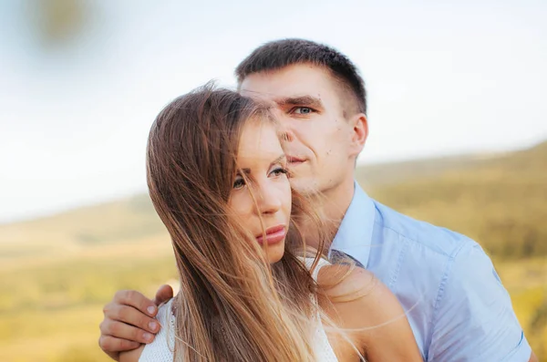 couple in love on a walk in the summer in the mountains