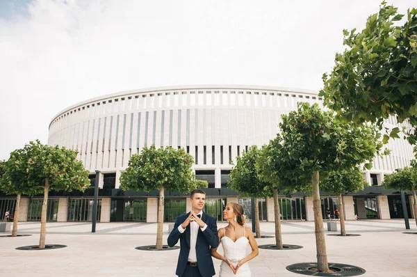 Snygg Brud Och Brudgummen Promenad Deras Bröllopsdag Park Nära Stadion — Stockfoto