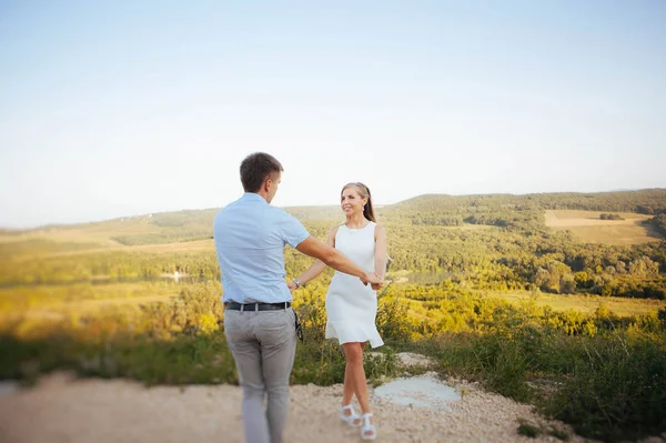 couple in love on a walk in the summer in the mountains