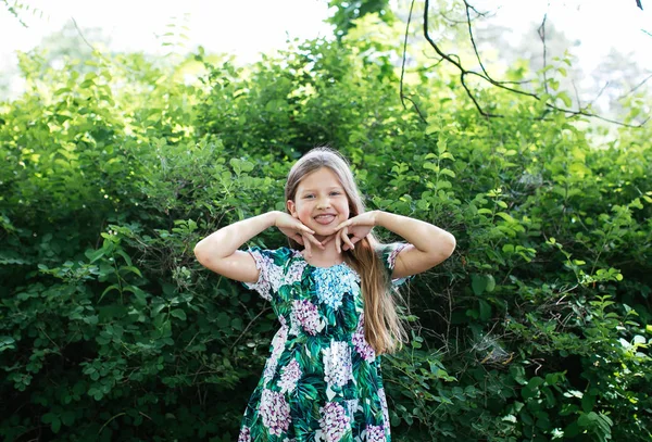 Blonde Teen Κορίτσι Ένα Φόρεμα Λουλούδι Θέτοντας Ένα Καταπράσινο Πάρκο — Φωτογραφία Αρχείου