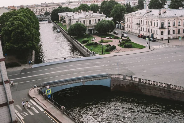 couple in love runs over the bridge in a large old city, photo from above