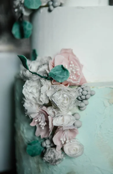 婚礼蛋糕是非常精美的装饰与白色糖霜和马子潘花 — 图库照片
