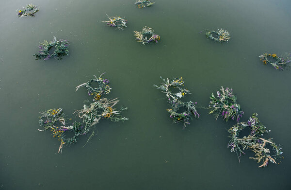 wreaths float in the lake at the pagan festival of spring