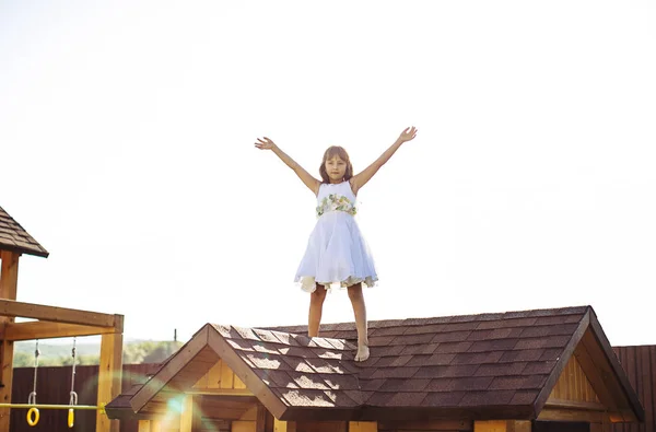 Χαριτωμένο Κορίτσι Λευκό Φόρεμα Στην Οροφή Του Σπιτιού — Φωτογραφία Αρχείου