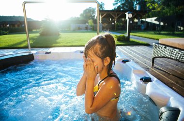 Küçük kız bir swimmin g havuzunda eğleniyor