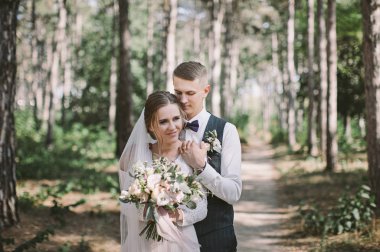 aşık şık ve ihale çift - gelin ve damat - ormanda bir yürüyüş onların düğün günü, gülerek ve sarılma