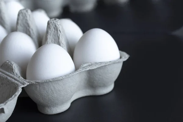 Ovos de galinha em uma bandeja de papelão no fundo — Fotografia de Stock
