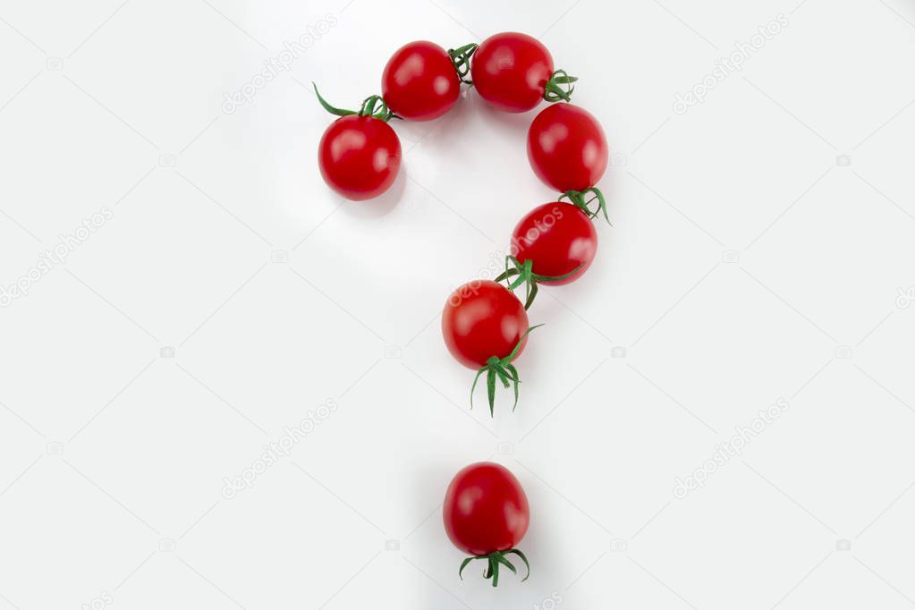 small red cherry tomatoes as a question mark