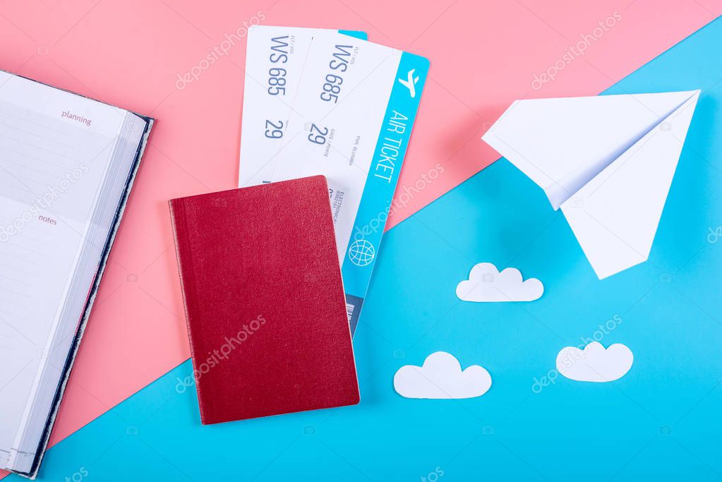 Air tickets with passport and paper plane on pastel background, topview. Bright background. The concept of air travel and holidays