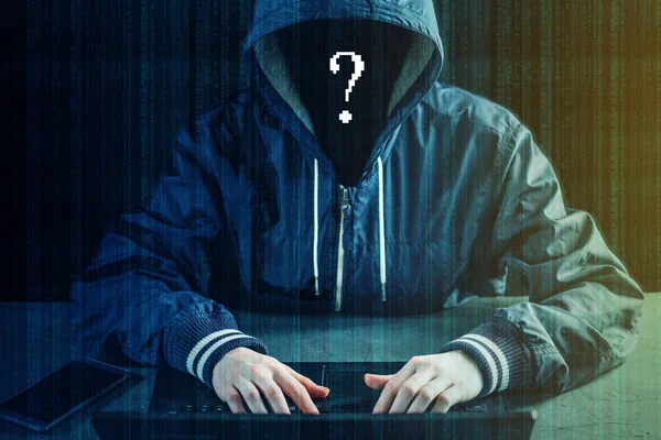 Anonymous hacker programmer uses a laptop to hack the system. Stealing personal data. Creation and infection of malicious virus. The concept of cyber crime and hacking electronic devices