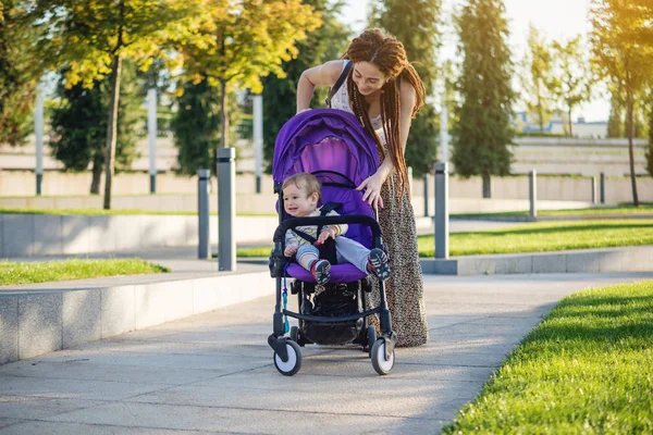 Young Modern Mother Baby Son Stroller Walking Sunny Park Concept — Stock Photo, Image