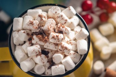 Bir bardak sıcak çikolata marshmallow üst ve arka planda çikolata ve tarçın bir lolipop sopa ile. Rahat bir Noel ev tatil kavramı