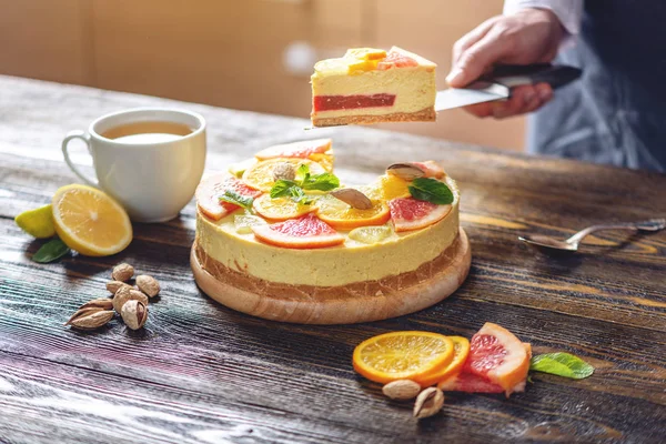 Кусок сырого цитрусового торта с грейпфрутом, апельсином, лаймом и лимоном. Готовить здоровый летний веганский десерт — стоковое фото