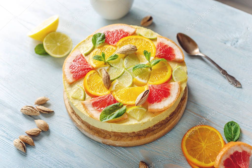 Raw citrus cake with grapefruit, orange, lime and lemon with nuts and mint. Healthy fresh summer vegan dessert