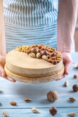 Ceviz, badem, fındık tepesi ile Nutty cheesecake. Mavi önlük süslenmiş ev yapımı tatlı şekerleme.