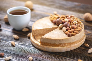 Koyu ahşap arka plan üzerinde ceviz, badem, fındık ile süslenmiş çiğ fındık kek. Glutensiz ve şekersiz ürün