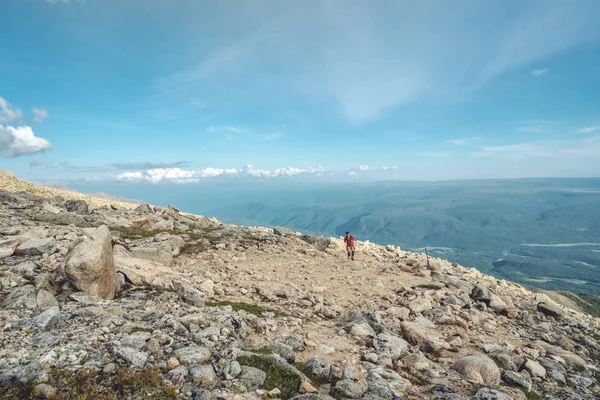 Beautiful view of mountains from the peak. Landscape with clouds and stones at sunset. Concept of climbing and Hiking