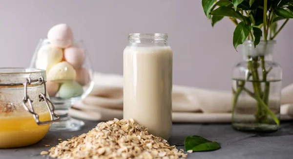 Vegetable natural oat milk on the table. A healthy alternative vegetarian drink for a healthy diet