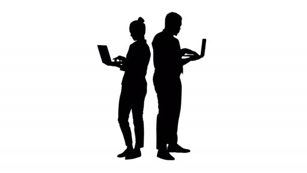 Silhouet Paar rug aan rug staande en werkend op laptops. — Stockvideo