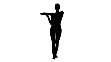 Siluet Genç kadın yoga elbisesi içinde ellerini uzatıyor.