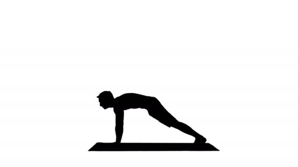 Silhouettenprofil eines muskulösen, gut aussehenden jungen Mannes beim Training, der in Yoga-Haltung nach oben, nach unten gerichteter Hundehaltung steht und dann die Arme ausstreckt. — Stockvideo