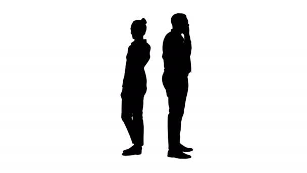 Silhouette Young African American man and woman standing back to back making phone calls. — Stock Video