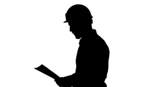 Silhouette Contractor engineer walking with papers and checking arround. — Stock Video