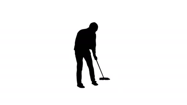 Silhouette Young man cleaning floor with brush. — Stock Video