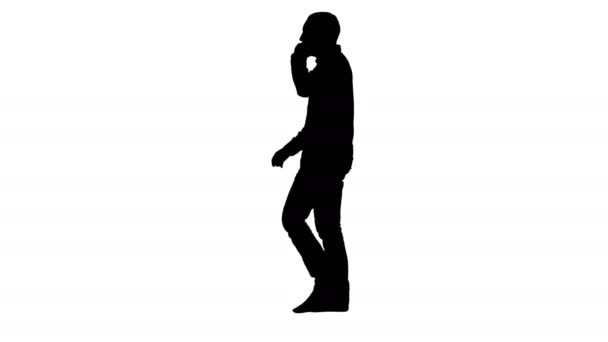 Silhouette Young bearded man walking and talking on the mobile phone. — Stock Video