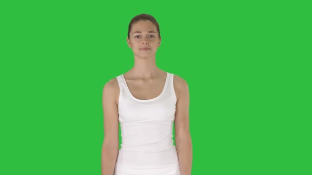 Leende fitness kvinna gående på en grön skärm, Chroma Key. — Stockvideo