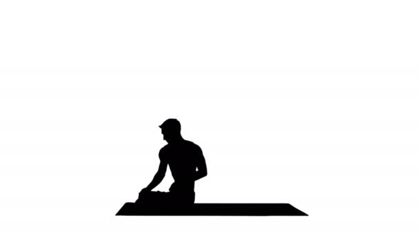 Silueta Un joven fuerte haciendo ejercicios de yoga estira las piernas padmasana . — Vídeos de Stock